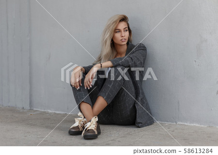 Pretty stylish young blond girl in a strict suit Pretty stylish young blond girl in a strict suit 58613284