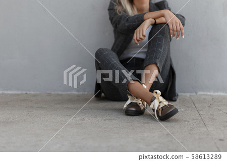 Fashionable stylish girl in a vintage gray suit Fashionable stylish girl in a vintage gray suit 58613289