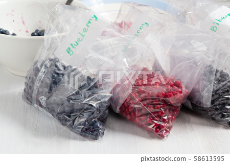 Berries laid out on a bags and prepared for freezing and storage Berries laid out on a bags and prepared for freezing and storage 58613595