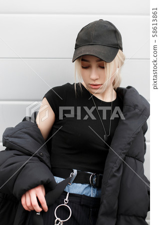 Beautiful young woman in a fashion black cap Beautiful young woman in a fashion black cap 58613861