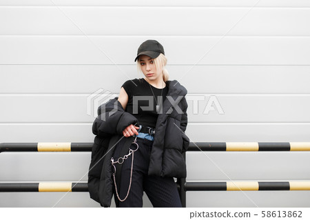 Beautiful fashionable girl with a black cap Beautiful fashionable girl with a black cap 58613862