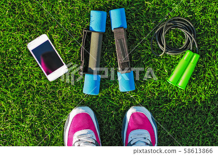 Sport concept. Female legs with sneakers Sport concept. Female legs with sneakers 58613866