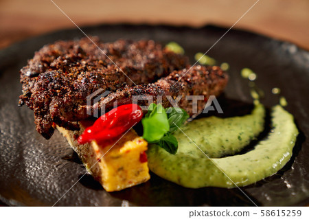Delicious steak with spinach sauce. Delicious steak with spinach sauce. 58615259