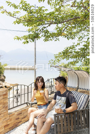 Couple drinking beer in villa garden Couple drinking beer in villa garden 58616029