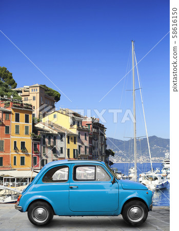 Beautiful red retro car parked by the road 58616150