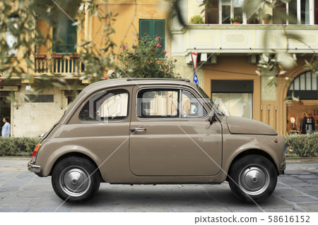 Beautiful red retro car parked by the road 58616152