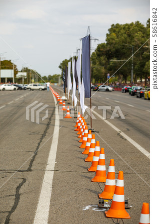 orange traffic cones in the middle of the road. orange traffic cones in the middle of the road. 58616842