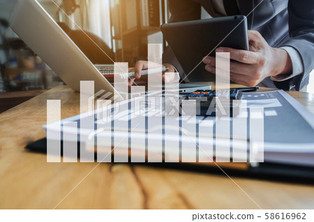 Male businessman working on desk office with using a calculator to calculate the numbers, finance accounting concept. Male businessman working on desk office with using a calculator to calculate the numbers, finance accounting concept. 58616962