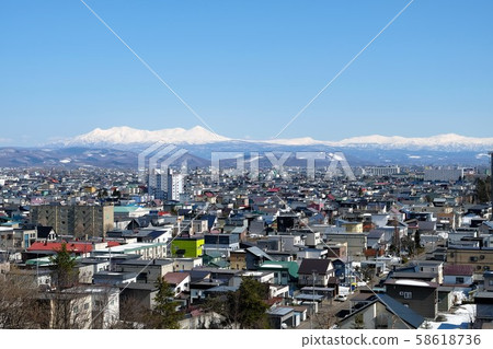Daisetsuzan mountain range seen from Asahikawa city, Hokkaido 58618736