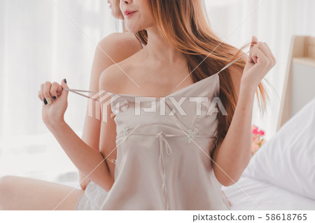 Women in pajamas sit on white bed is sexy in Women in pajamas sit on white bed is sexy in 58618765