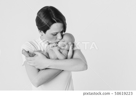 photo in black and white: the mother holds her son in her arms. Family portrait: a woman with a child. Health care concept: healthy family 58619223