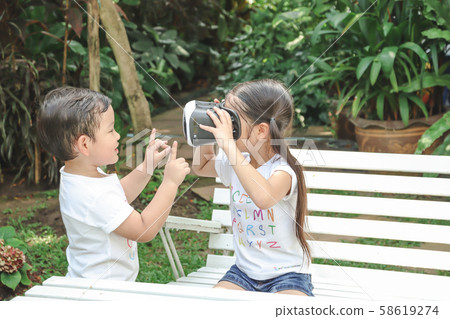 Kids Sister holding virtual reality, vr for boy Kids Sister holding virtual reality, vr for boy 58619274