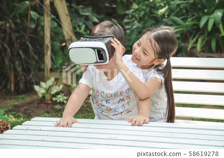 Kids Sister holding virtual reality, vr for boy Kids Sister holding virtual reality, vr for boy 58619278