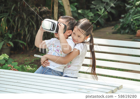 Kids Sister holding virtual reality, vr for boy Kids Sister holding virtual reality, vr for boy 58619280