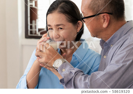 Elderly husband and wife drink milk in the morning Elderly husband and wife drink milk in the morning 58619320