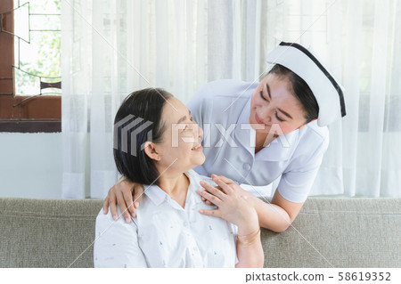 Caregiver of nurse hold hand withElderly of 58619352