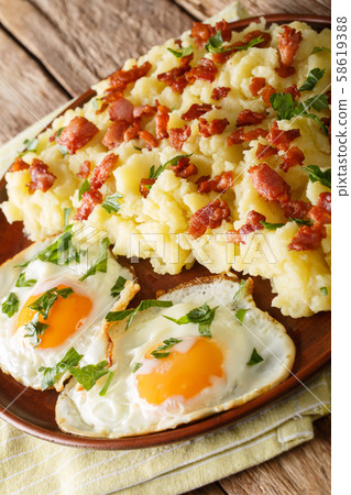 Mashed potato with bacon served with fried eggs Mashed potato with bacon served with fried eggs 58619388