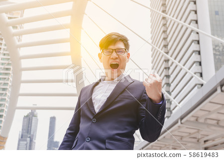 Businessman happy and excited expressing winning Businessman happy and excited expressing winning 58619483