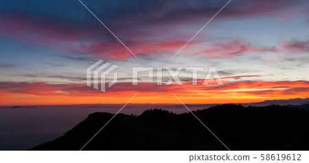 Dramatic red sky on dark woodland Dramatic red sky on dark woodland 58619612