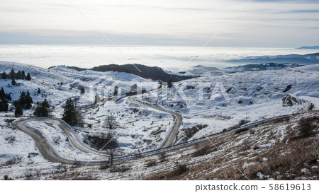 Mountain road with curves in winter season Mountain road with curves in winter season 58619613