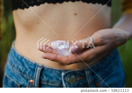 Female hands holding two yoni eggs for vumfit, imbuilding or meditation are made from pink quartz Female hands holding two yoni eggs for vumfit, imbuilding or meditation are made from pink quartz 58621113