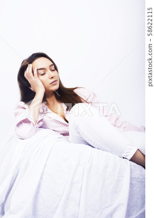 young pretty brunette woman in bed covered white sheets smiling cheerful, lifestyle people concept young pretty brunette woman in bed covered white sheets smiling cheerful, lifestyle people concept 58622115