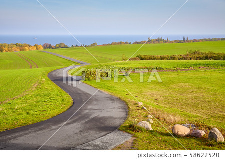 Scenic country road, Rugia island, Germany. 58622520