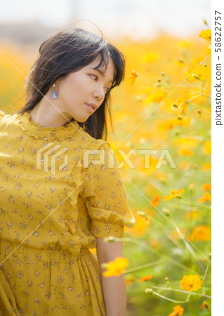 Portrait of woman with yellow flower Portrait of woman with yellow flower 58622757