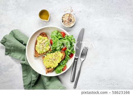 Avocado toast and kale tomato salad Avocado toast and kale tomato salad 58623166