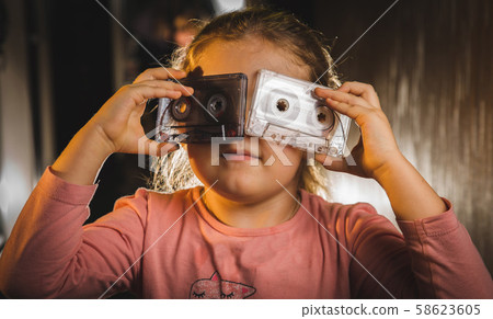 male hand with glove holding an old music tape male hand with glove holding an old music tape 58623605