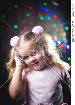 Girl with red hair on the phone wearing her Girl with red hair on the phone wearing her 58623676
