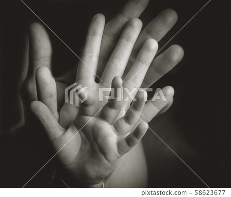 Fist of Dad and Newborn Baby 58623677