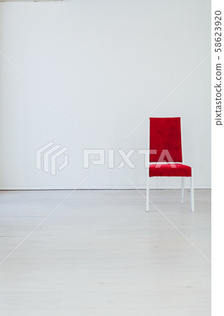 one red old chair in the interior of an empty white room one red old chair in the interior of an empty white room 58623920