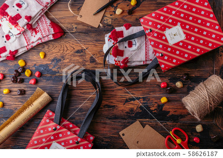 Gift boxes wrapped in red checked paper and the contents of a workspace composed. Flat lay 58626187