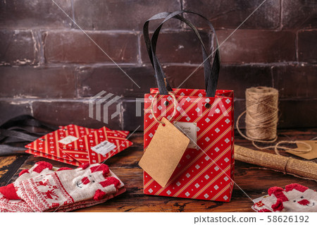 Gift boxes wrapped in red checked paper and the contents of a workspace composed. Flat lay 58626192