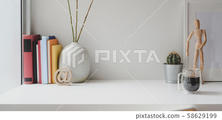 Comfortable workspace with books, office supplies Comfortable workspace with books, office supplies 58629199