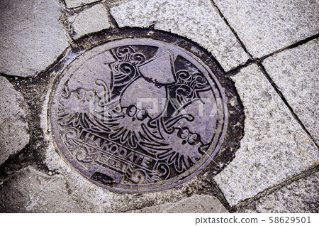 Hakodate manhole sewage cover on street - Japan 58629501