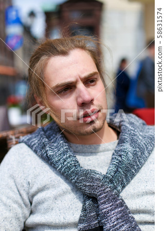 Portrait of handsome caucasian man wearing grey sweater. Portrait of handsome caucasian man wearing grey sweater. 58631574