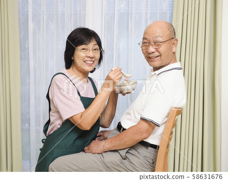 Senior woman eating porridge Senior woman eating porridge 58631676