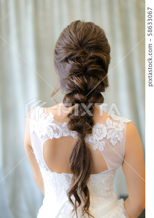Back view of brunette fiancee with braid hair at photo studio. Back view of brunette fiancee with braid hair at photo studio. 58633067