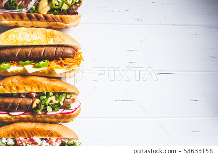 Hot dogs with different toppings 58633158