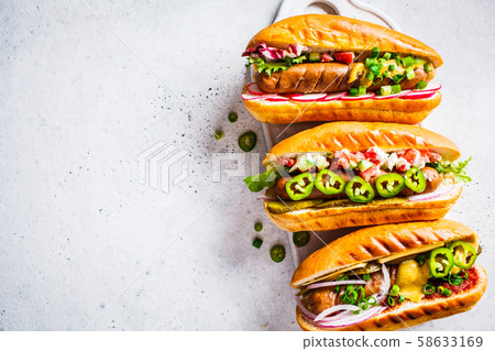 Hot dogs with different toppings  58633169