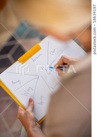Psychoanalyst writing down while making the investigation 58634197