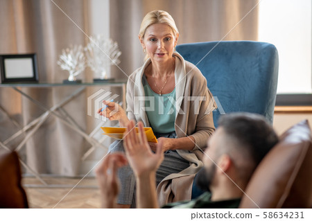 Psychologist providing psychological support to a man Psychologist providing psychological support to a man 58634231
