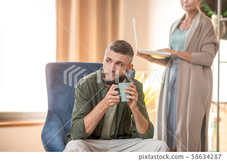 Bearded man feeling thoughtful while visiting psychoanalyst 58634287