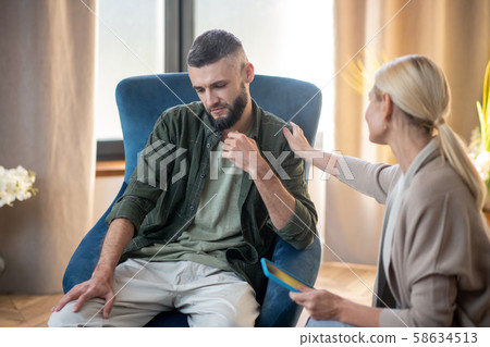 Bearded man feeling better after talking with psychoanalyst 58634513