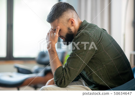 Man sitting near window and waiting for his psychoanalyst Man sitting near window and waiting for his psychoanalyst 58634647