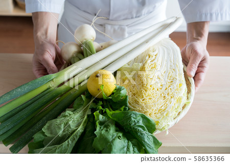 In front of a board with colander with vegetables 58635366
