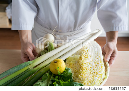 In front of a board with colander with vegetables 58635367