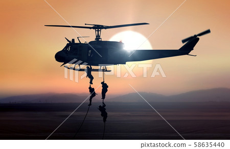 Military commandos helicopter drops during sunrise Military commandos helicopter drops during sunrise 58635440